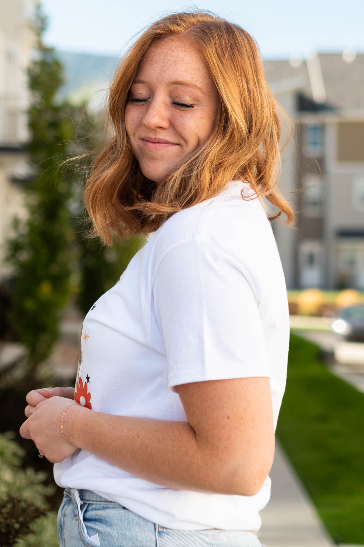 Side view of a happy haunt white tee