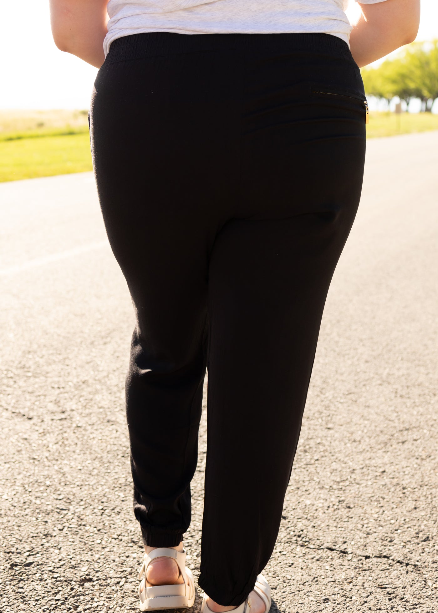Back view of plus size black joggers