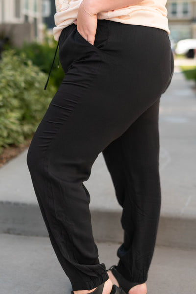 Side view of plus size black joggers with pockets