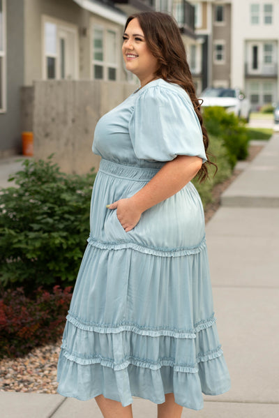 Side view of a plus size french blue dress with pockets