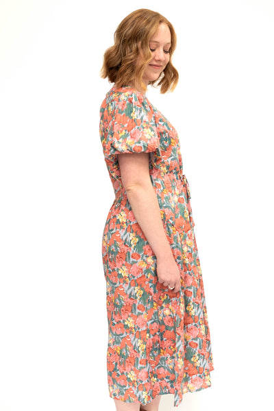 Side view of a medium coral floral dress