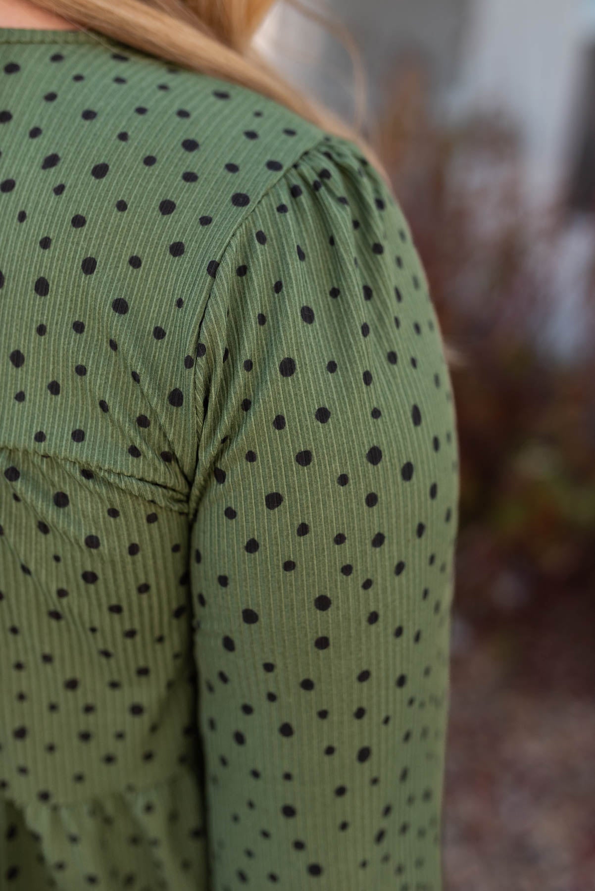 Close up of the fabric of the olive tiered top