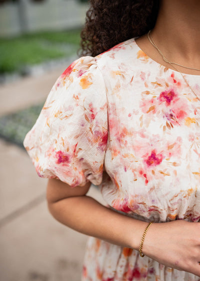 Close up of the fabric and sleeve of the multi floral printed dress
