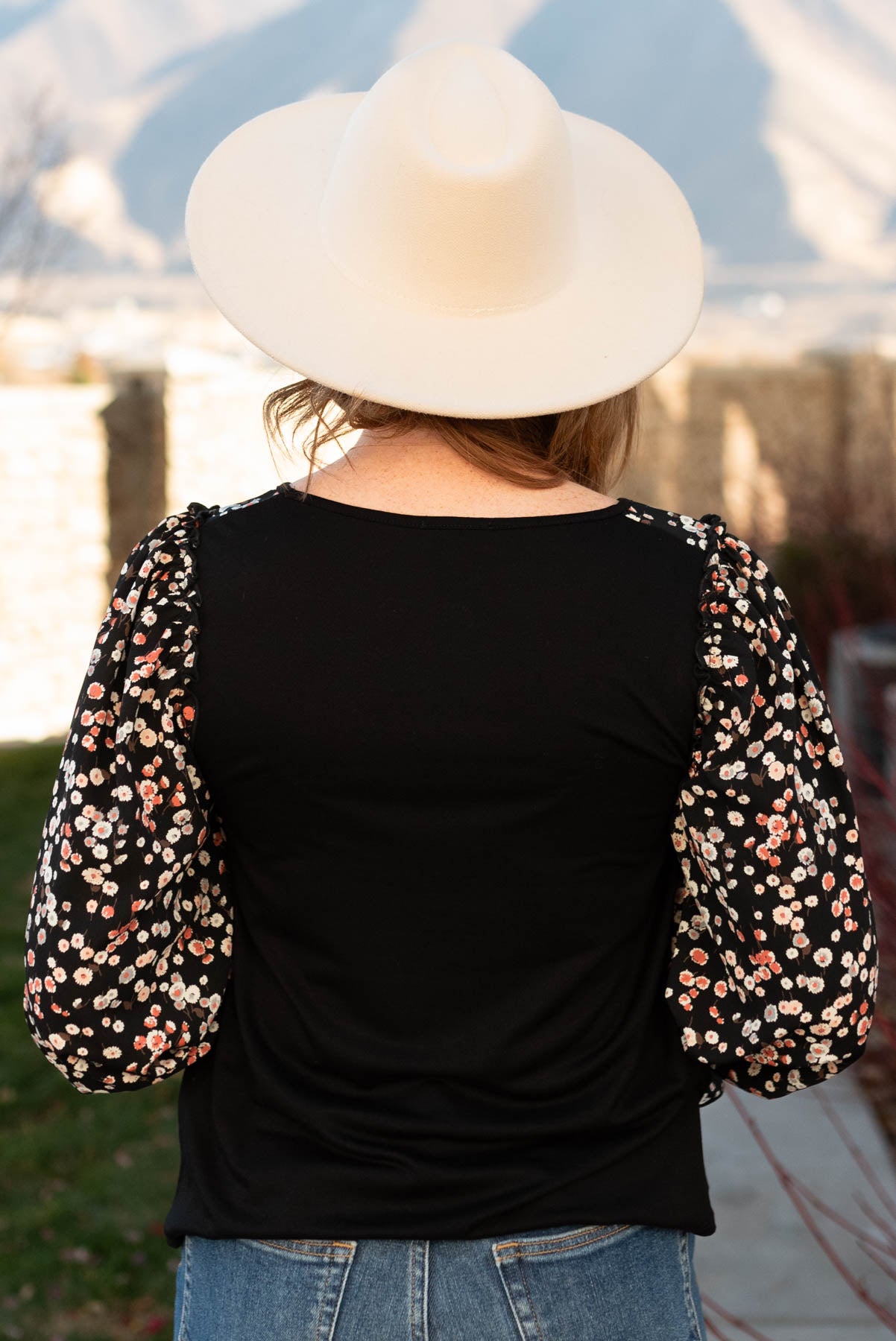 Back view of a black pattern sleeve top