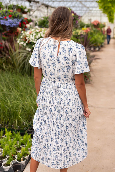 Back view of the blue floral pleated dress