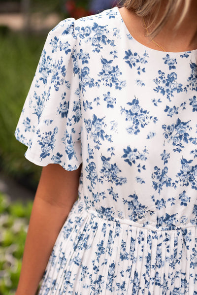 Close up of the fabric on the blue floral pleated dress