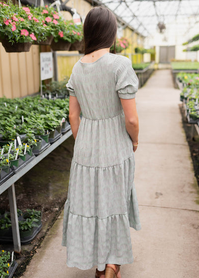 Back view of the pink and green gingham dress