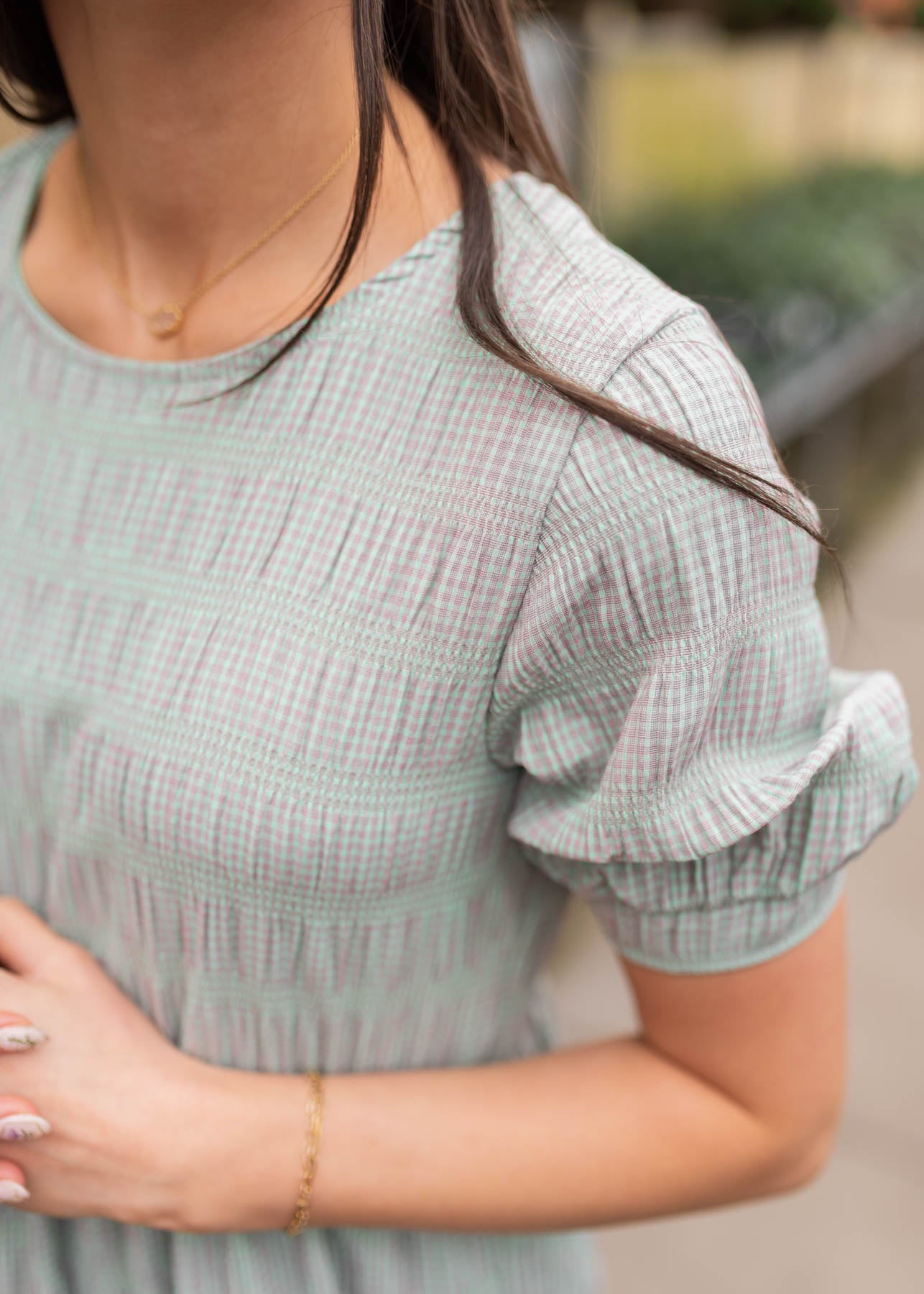 Close up of the sleeve and fabic on the green gingham dress