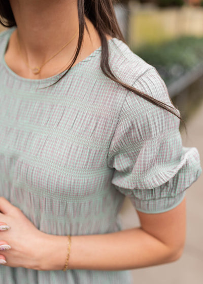 Close up of the sleeve and fabic on the green gingham dress