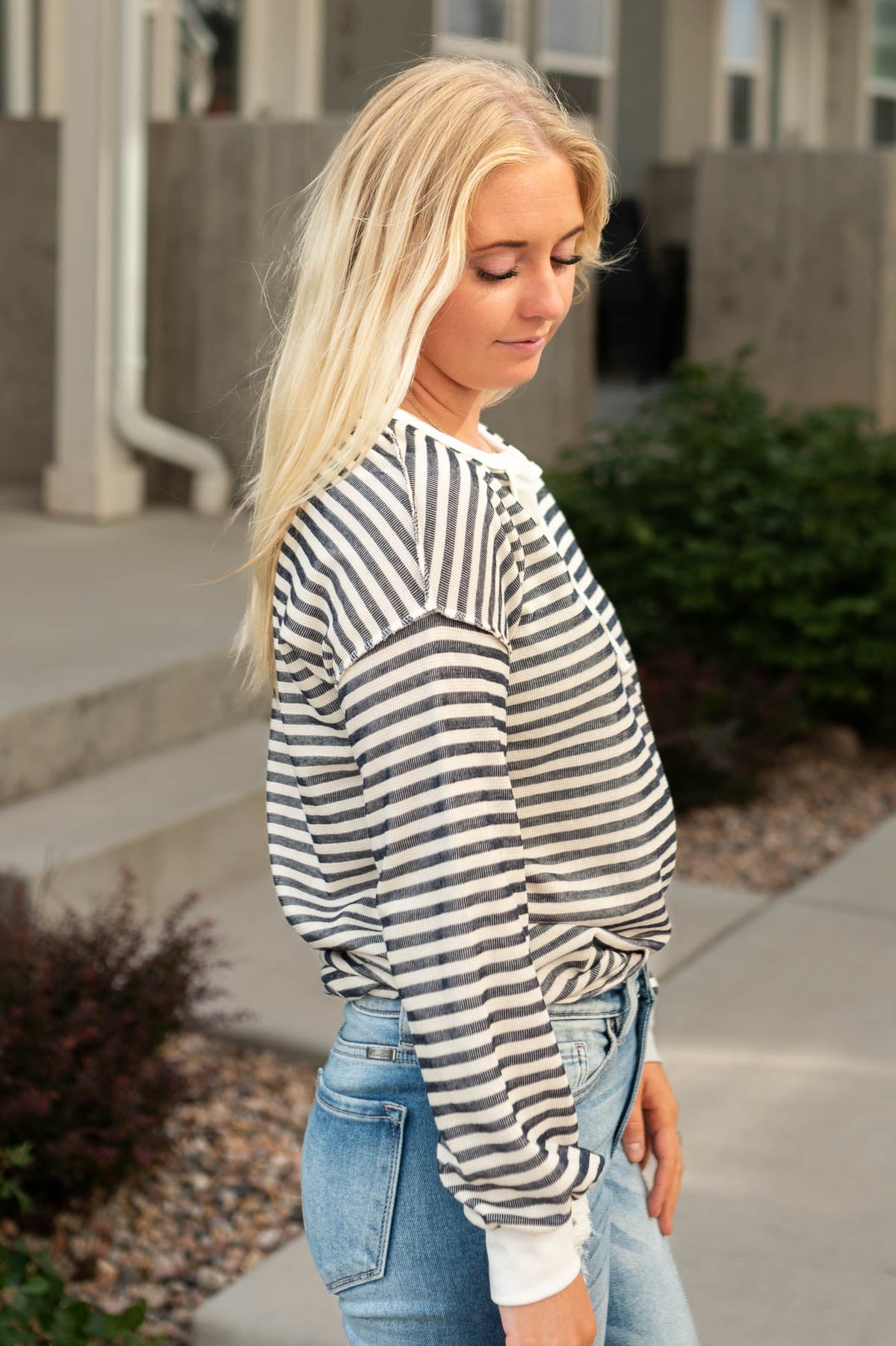 Side view of a long sleeve navy striped top
