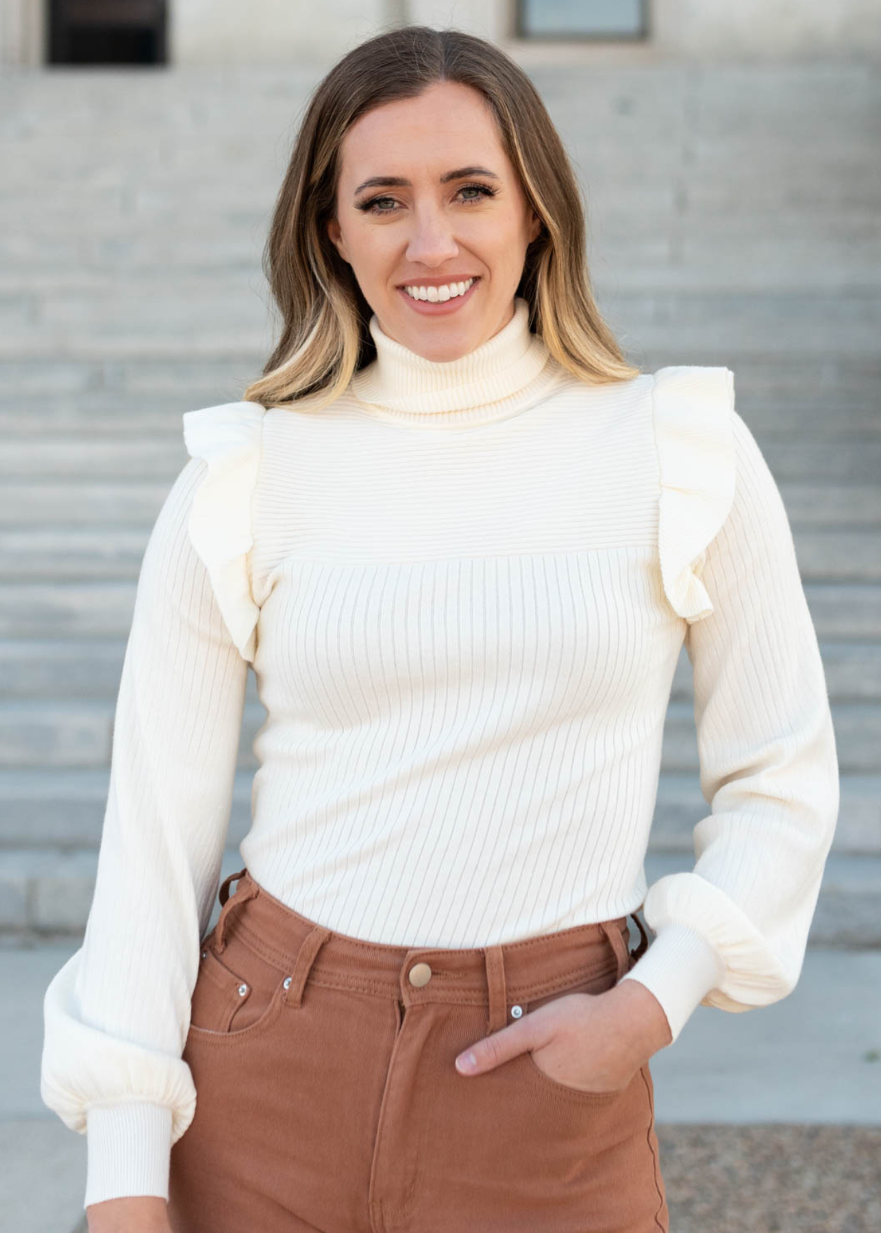 Ivory ruffle turtleneck sweater with ruffles at the shoulders