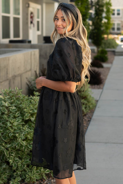 Side view of a black floral dress