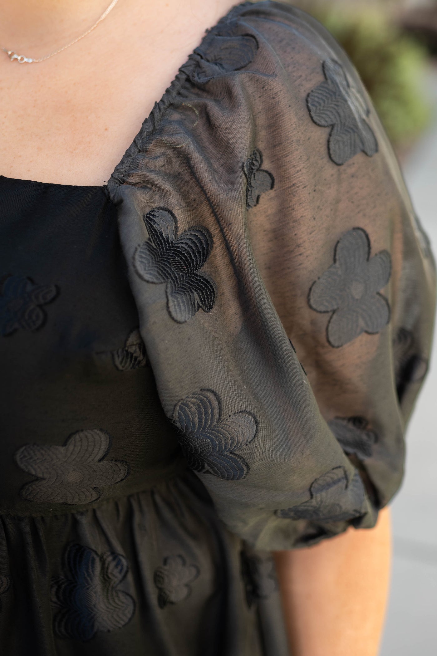 Short sleeve of a black floral dress