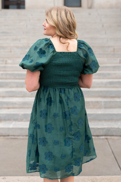 Back view of the hunter green floral dress with smocked back