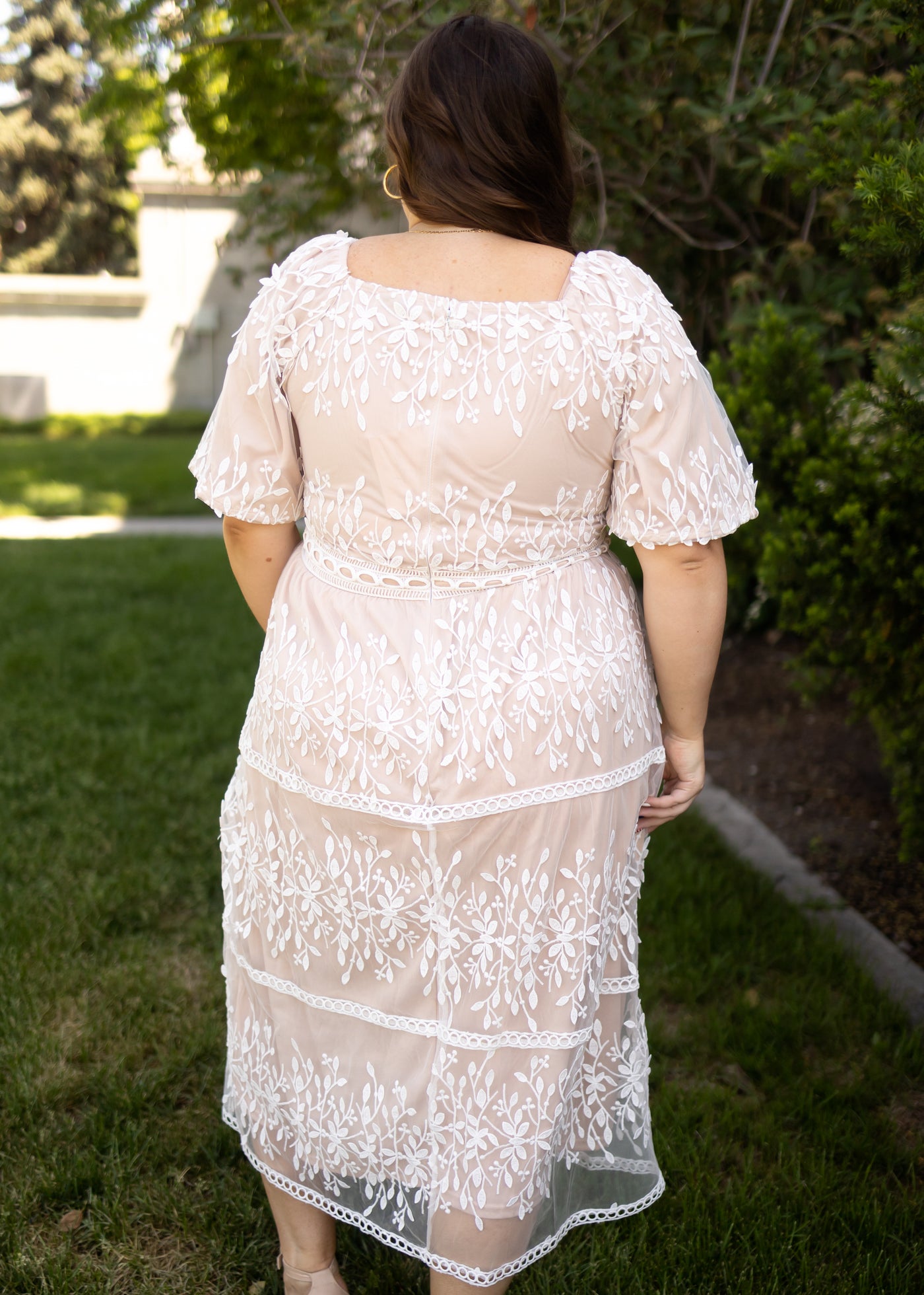Back view of a ivory lace dress with square neck