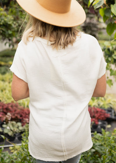 Back view of a white v-neck top
