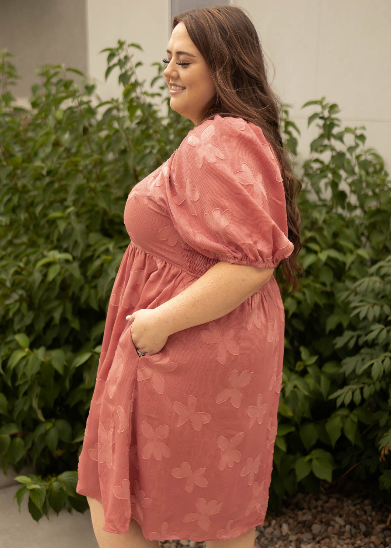 Side view of a plus size dusty rose dress