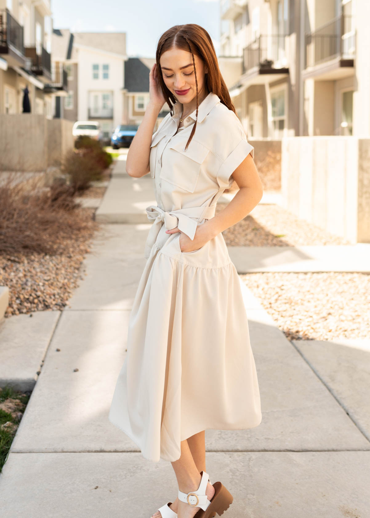 Side view of the beige button down dress with pockets