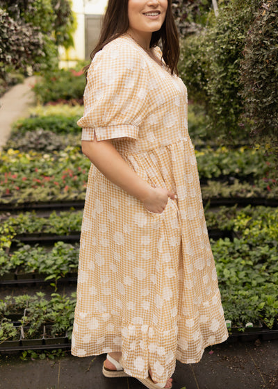 Side view of a plus size mustard dress
