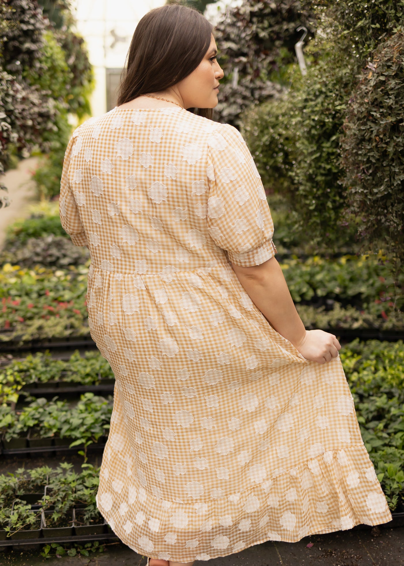 Back view of a plus size mustard dress