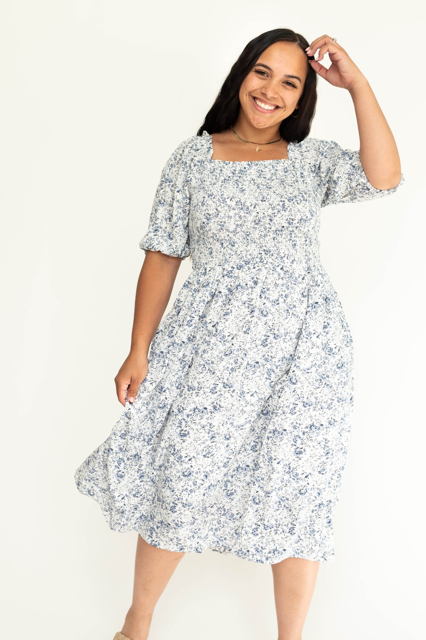 Plus size short sleeve blue floral dress with smocked bodice.