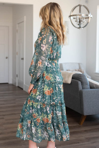 Side view of a dark green floral dress
