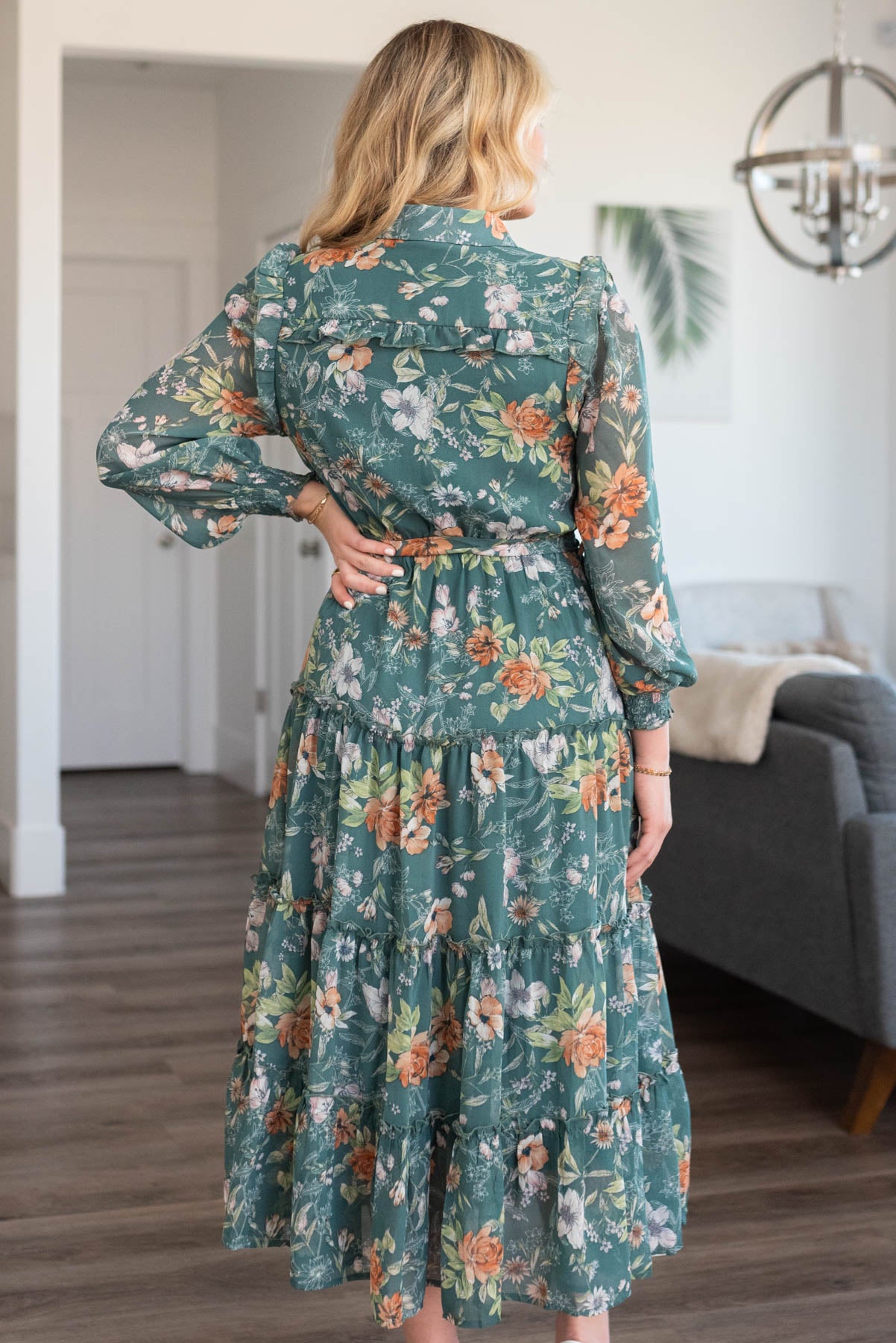Back view of a dark green floral dress