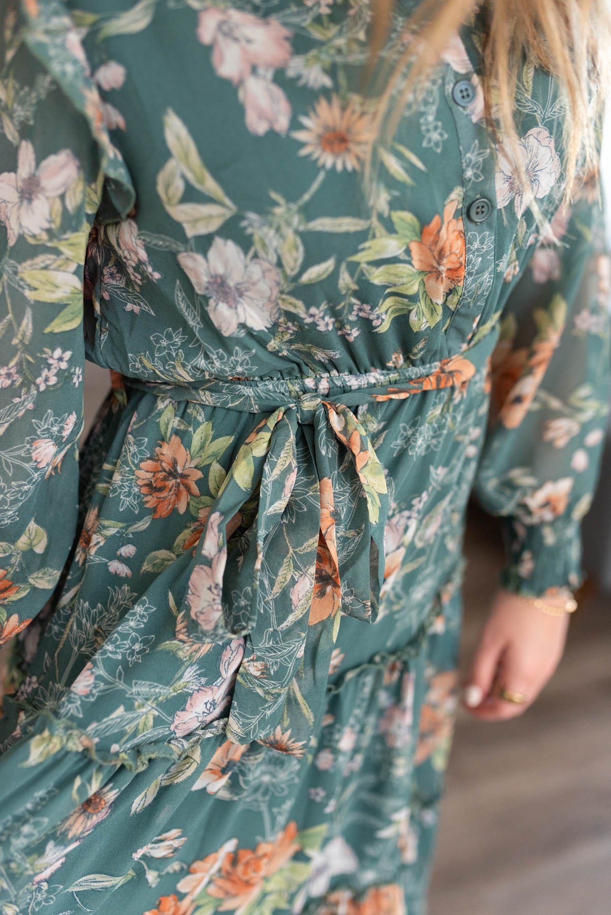 Close up of the fabric on a dark green floral dress