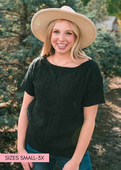 Front view of a short sleeve black knit top