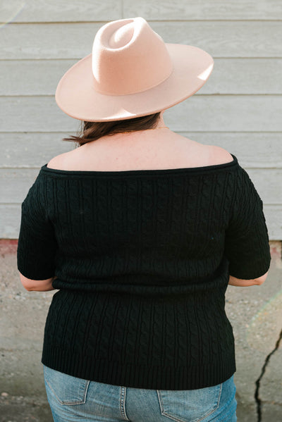 Back view of the plus size black knit top