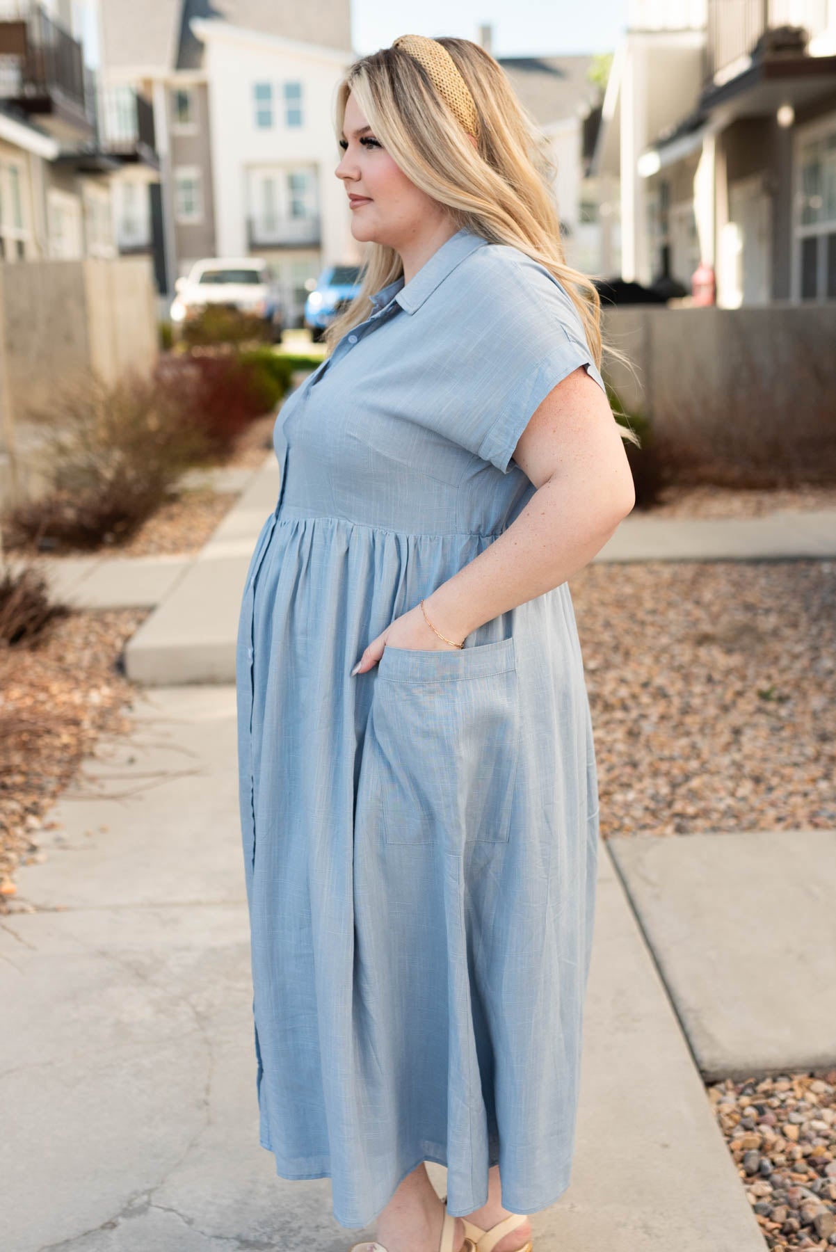Side view of the plus size blue button down dress