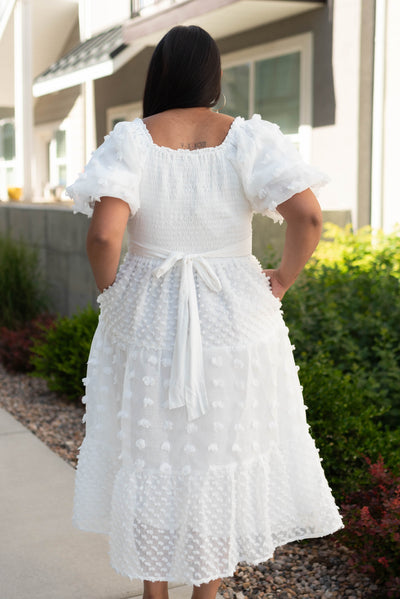 Back view of a large white dress that ties in the back