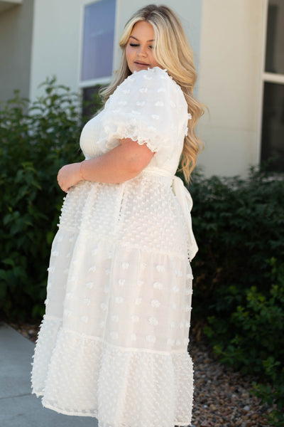 Side view of a plus size white dress that ties in the back