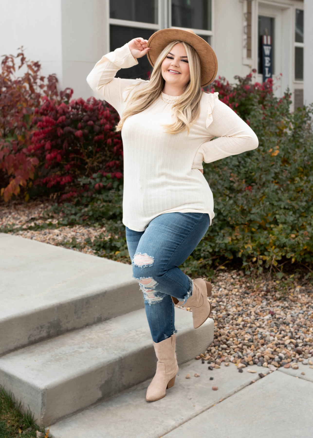 Plus size cream ruffle long sleeve top with ruffles at the shoulder