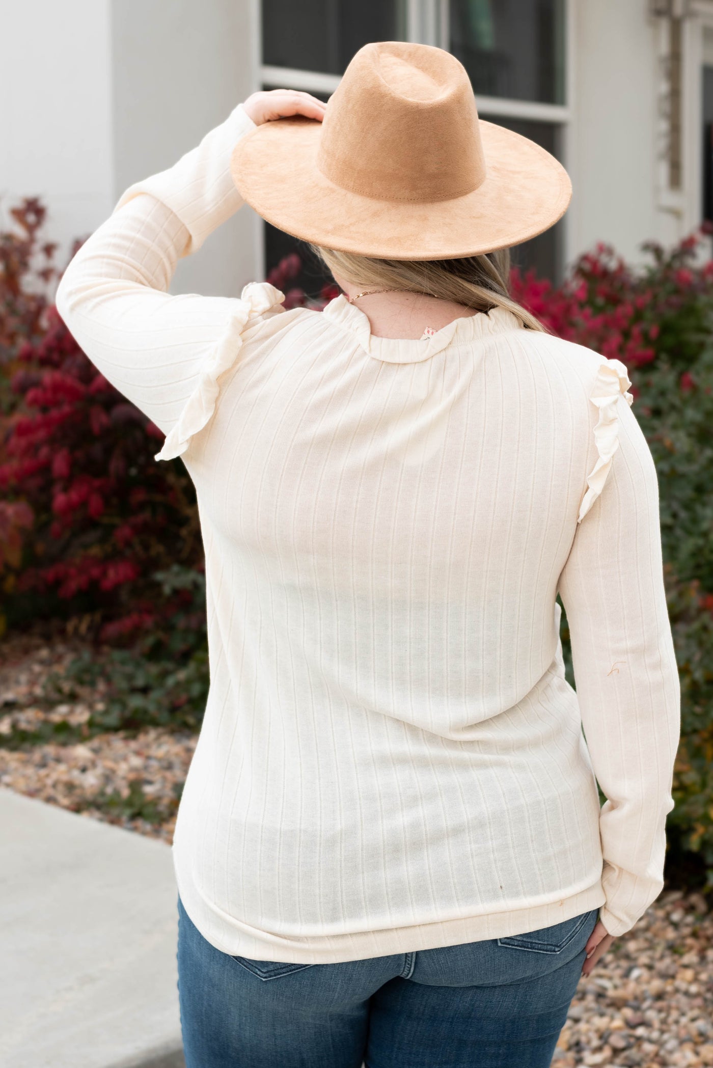 Back view of the plus size cream ruffle long sleeve top