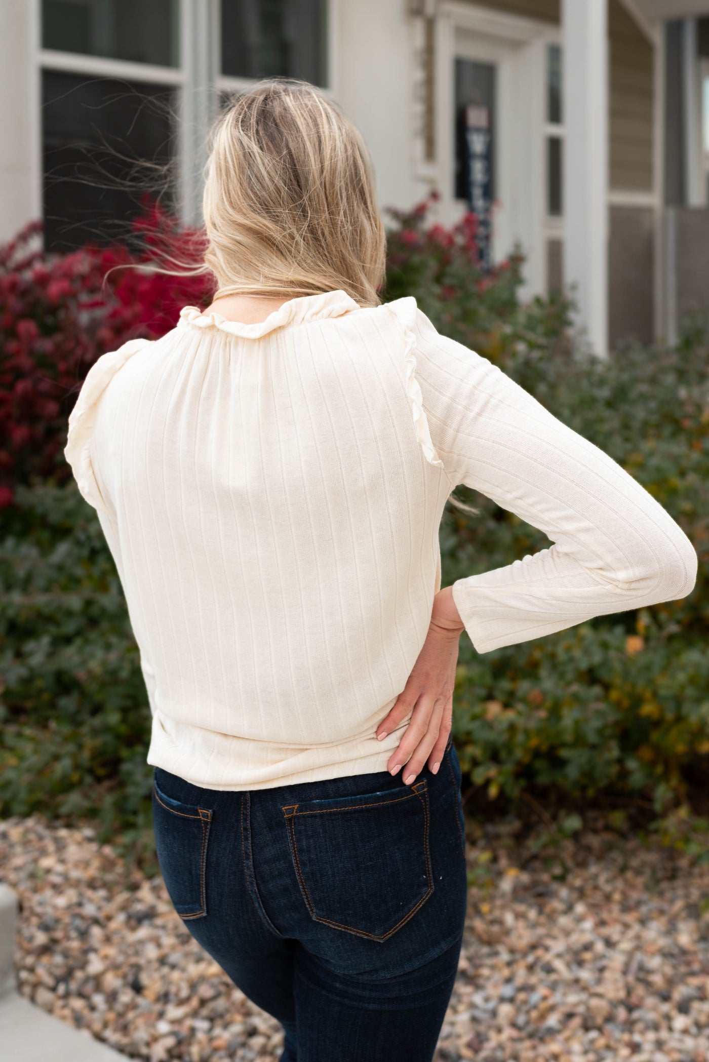 Back view of the cream ruffle long sleeve top