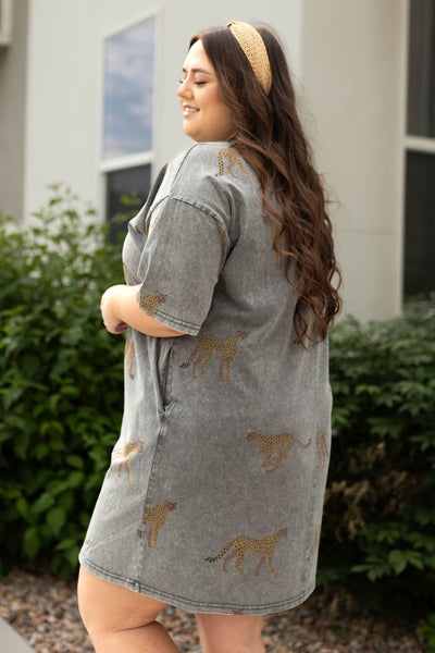 Side view of a plus size charcoal dress with pockets