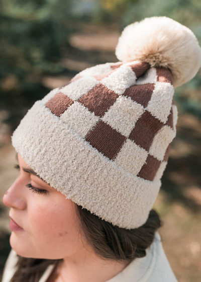 Side view of a taupe checkered beanie