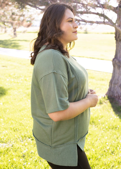 Side view of a plus size olive top