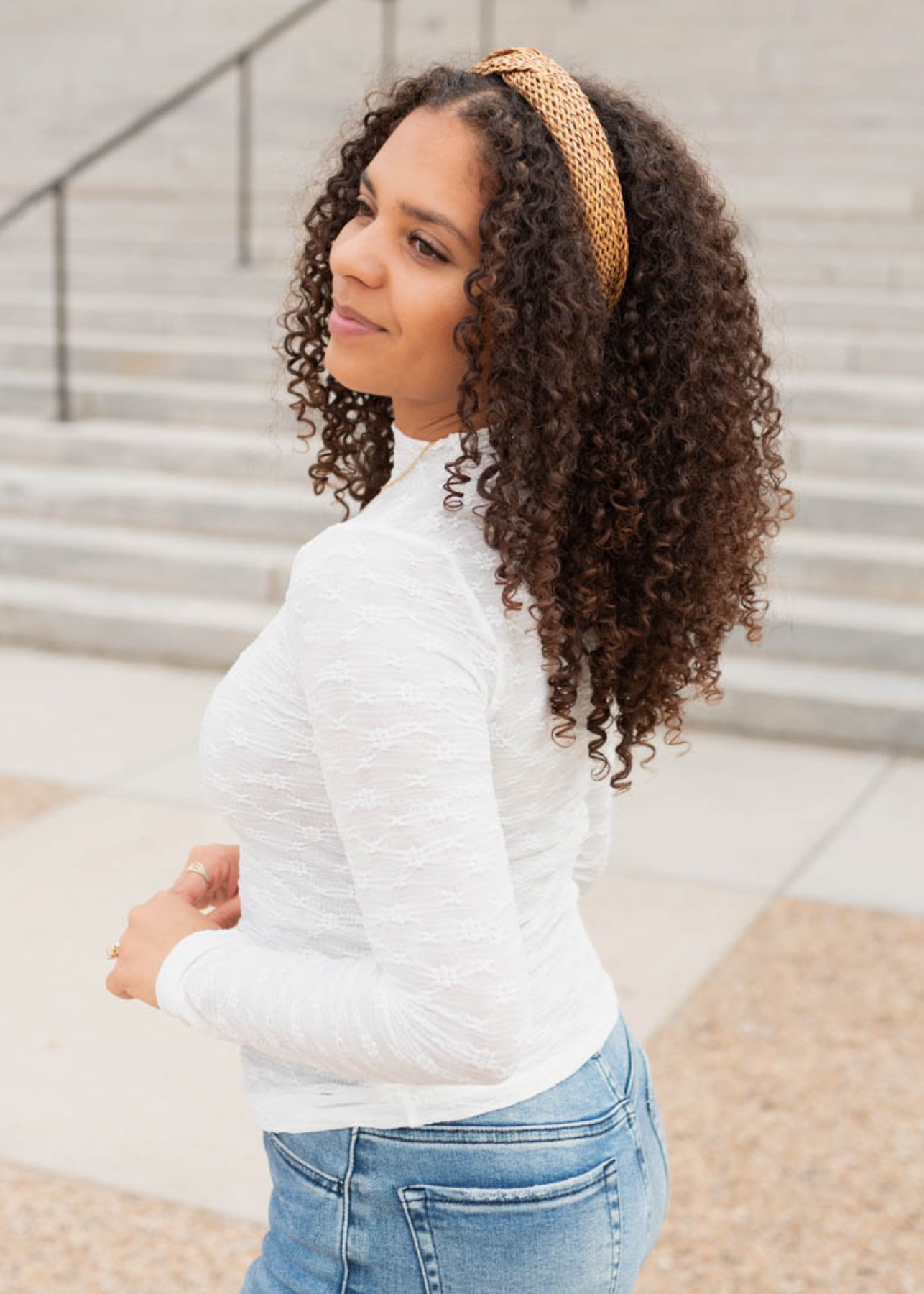 Side view of the white sheer floral lace top