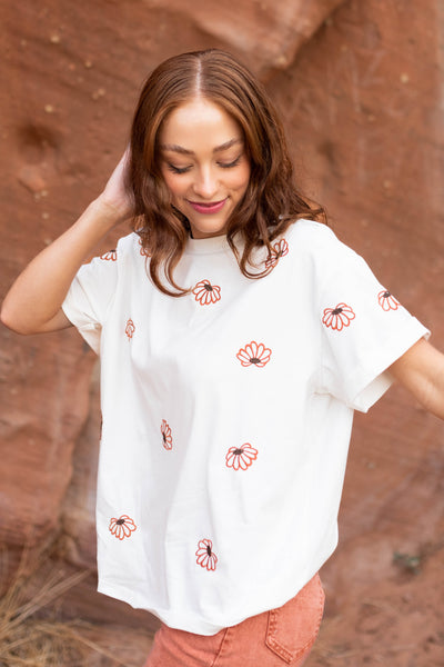 Ivory floral top with orange flowers and short sleeves