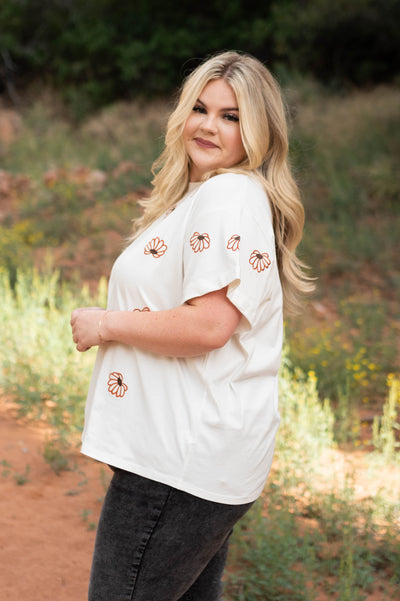 Side view of a ivory floral top