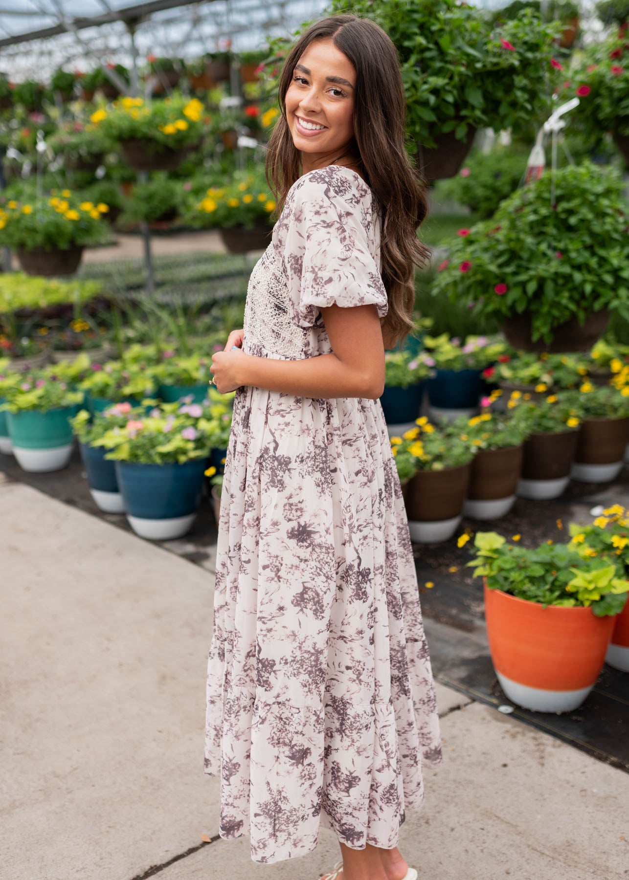 Side view of the cream floral smocked dress