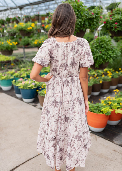 Back view of the cream floral smocked dress