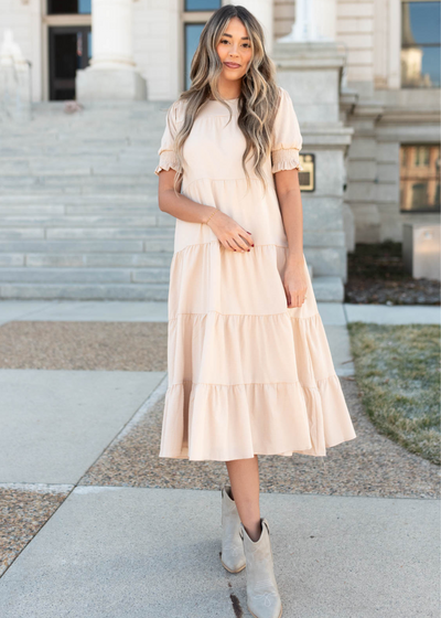 Tiered cream dress with a full skirt