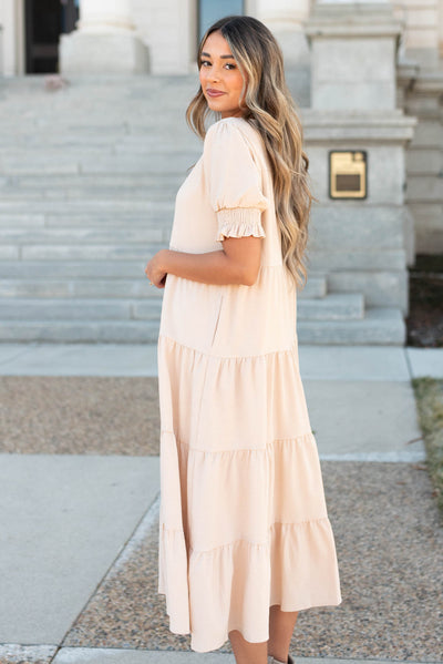 Side view of the tiered cream dress