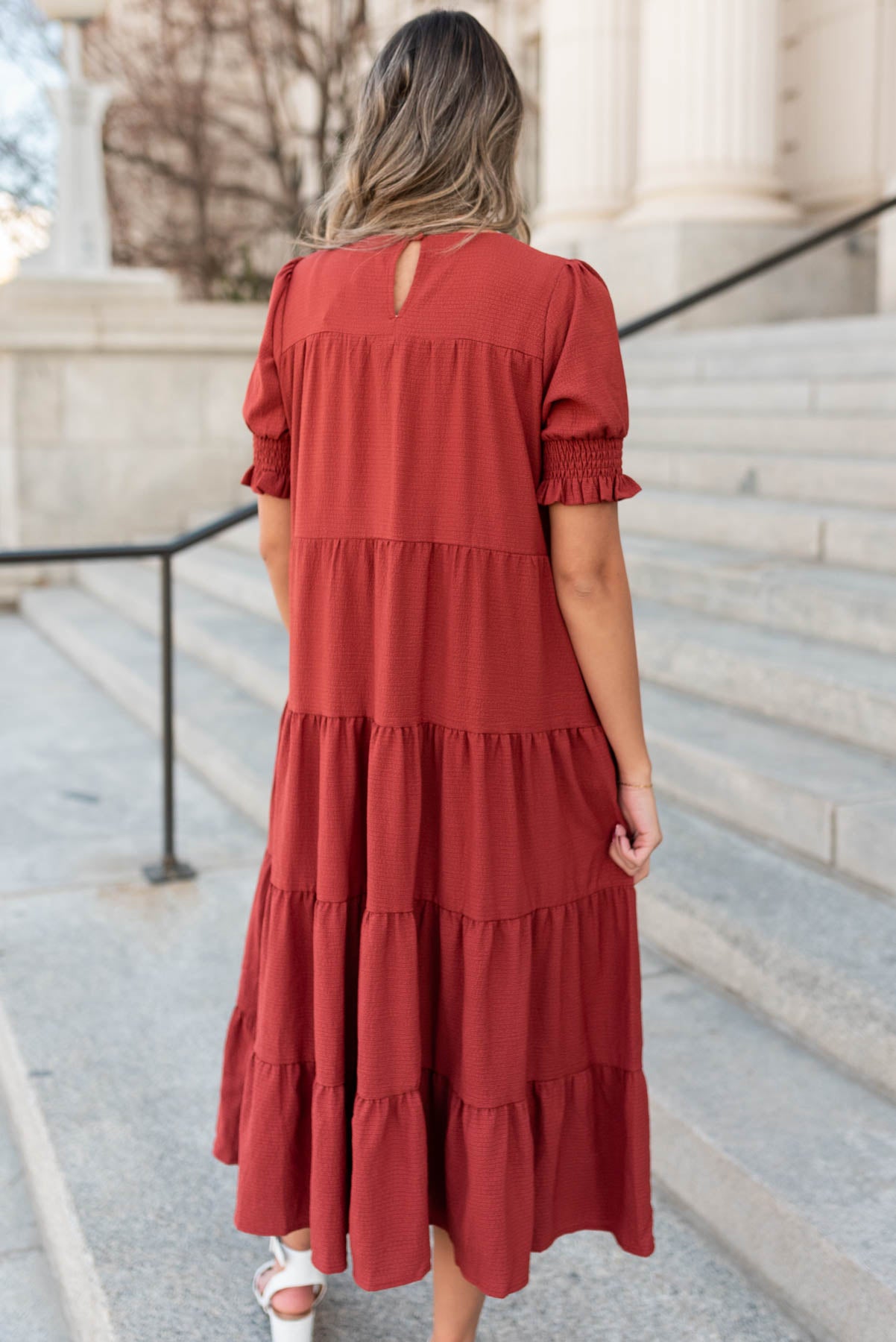 Back view of a tiered rust dress