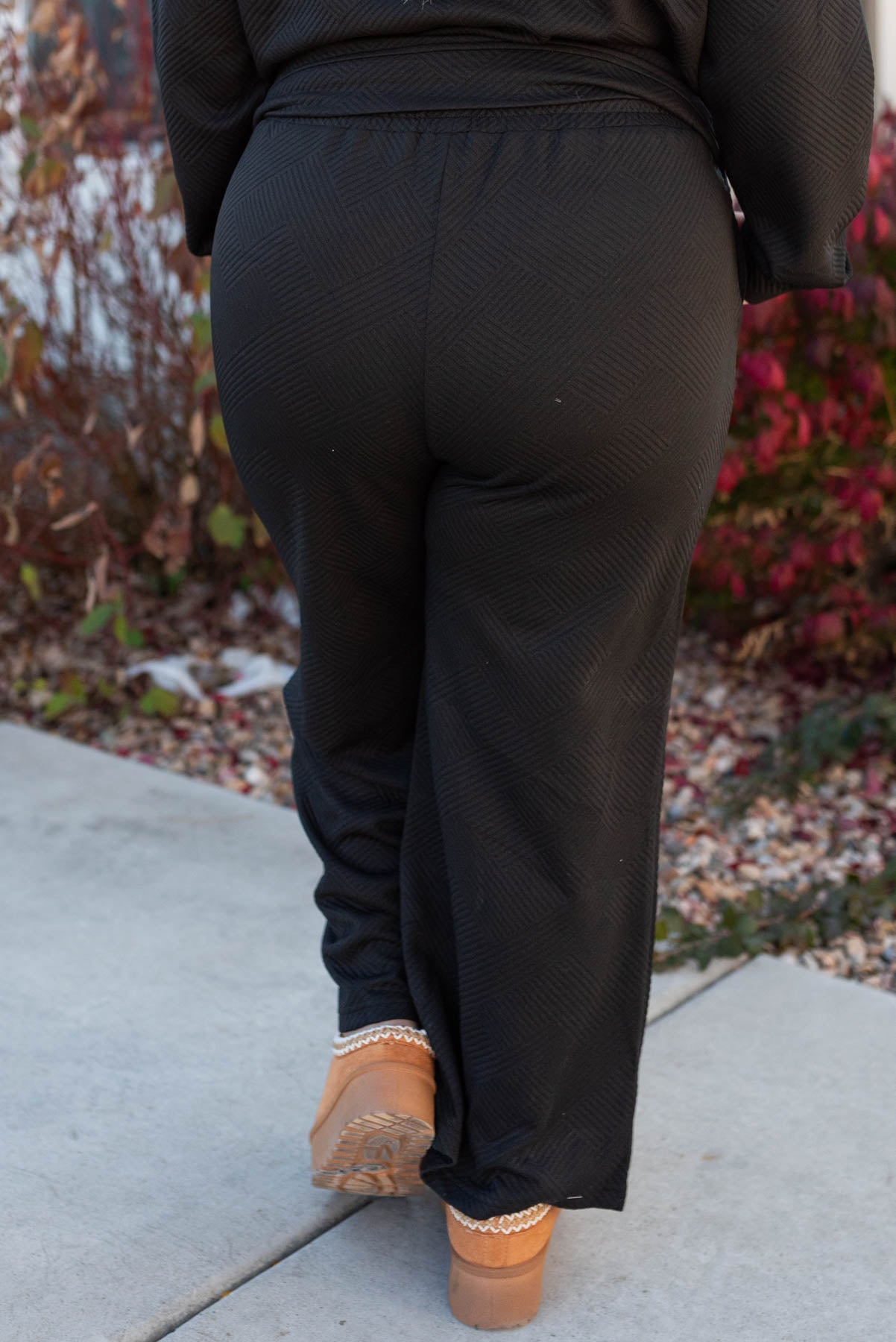 Back view of the plus size pants on the black textured lounge set