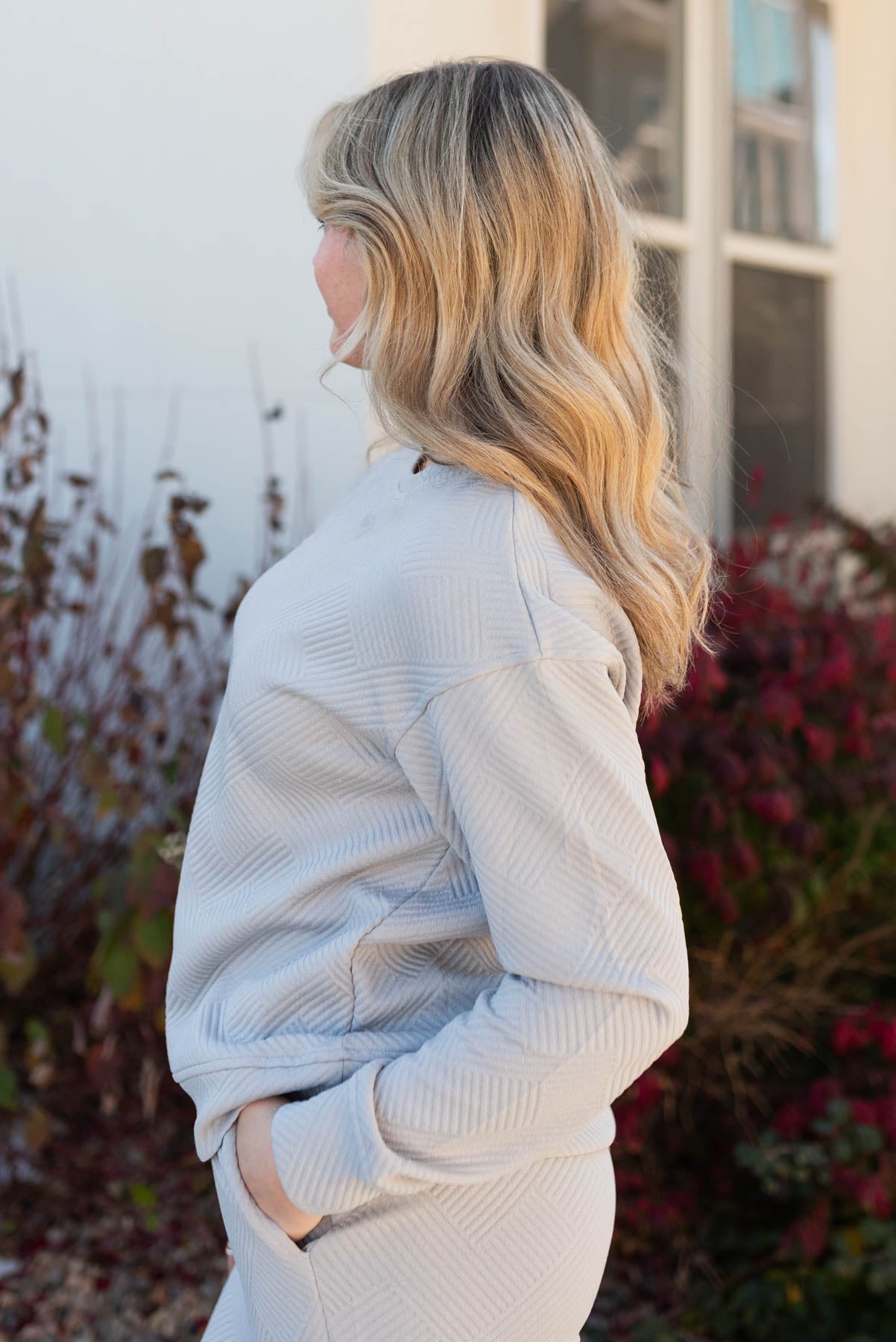 Side view of the grey textured lounge set with pockets