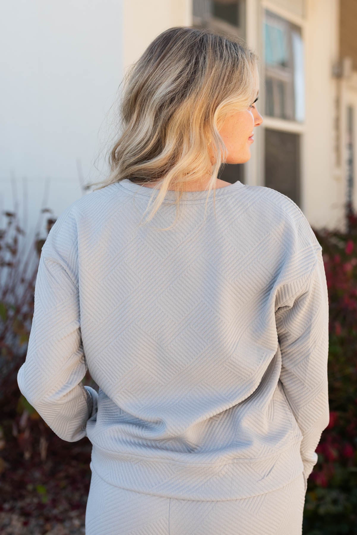 Back view of the top of a grey textured lounge set